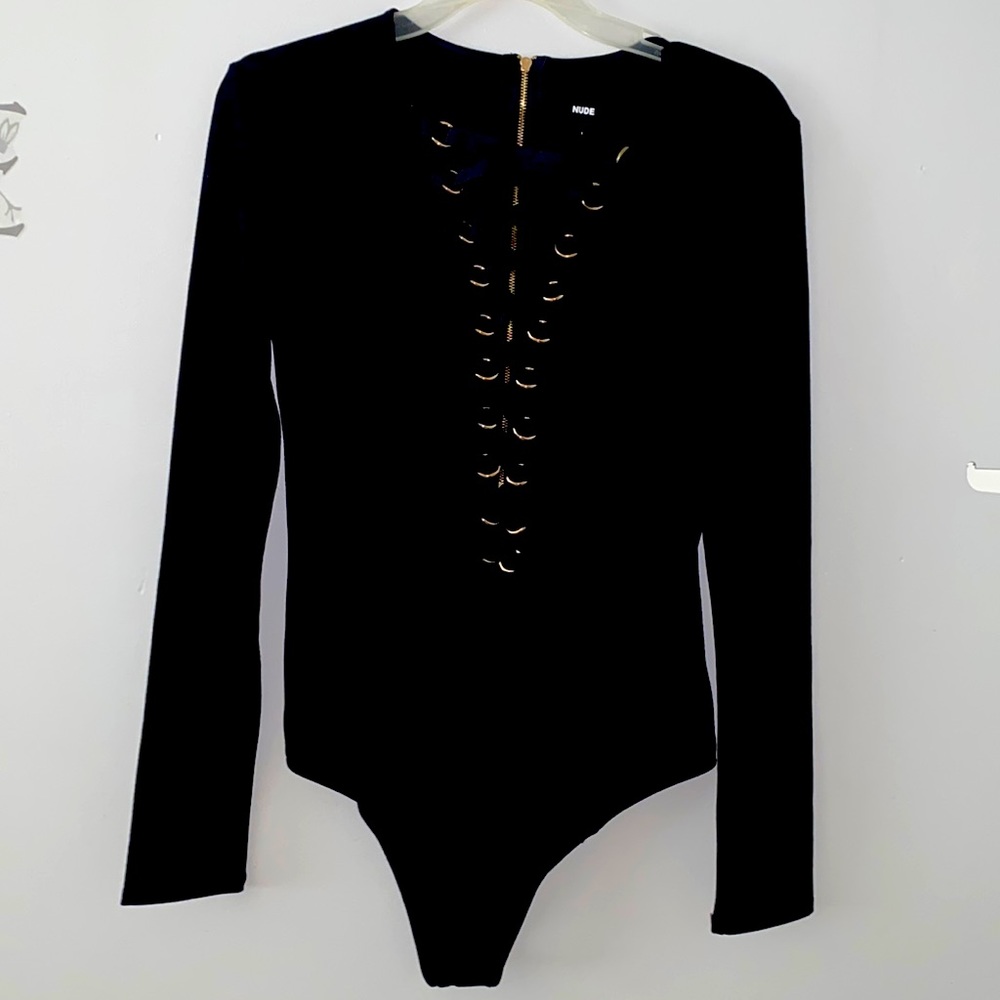 Body suit with ribbons and rings criss cross down the front zipper back closure.